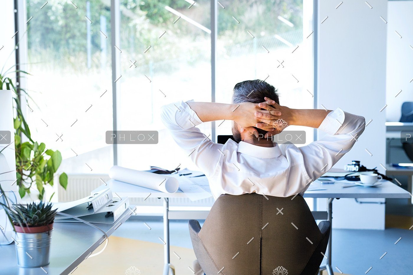 Businessman At The Desk In His Office Resting