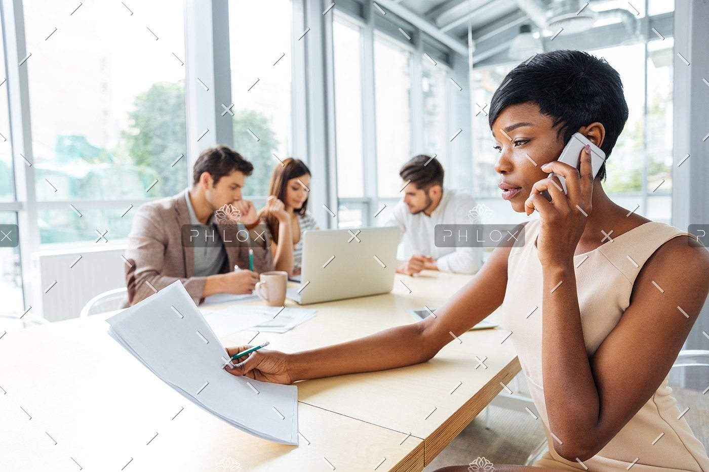 Serious Businesswoman With Documents Talking On P9Q6LX6