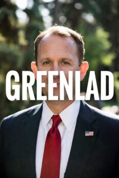 Man in suit and red tie boldly announcing "GREENLAD" with large white text overlaid on his face, trees in background