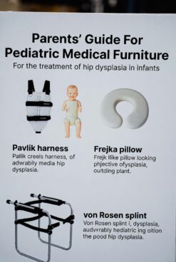 Baby positioned with Frejka pillow orthopedic brace for hip dysplasia, featuring soft padded support and straps.