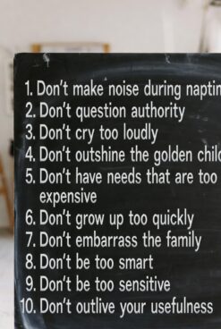 Black chalkboard listing 10 "invisible" childhood rules in white text, including "Don't cry too loudly", "Don't outshine the golden child" and "Don't be too sensitive"