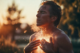 Man taking a deep, empowering breath outdoors at sunrise with glowing oxygen particles, representing strength and respiratory wellness.