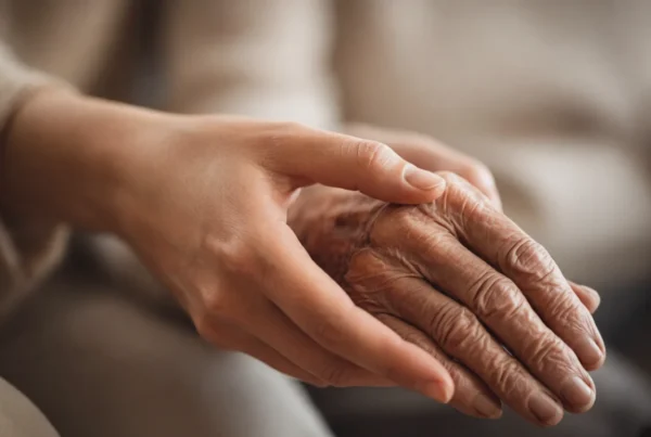 Young hand gently holding elderly wrinkled hand